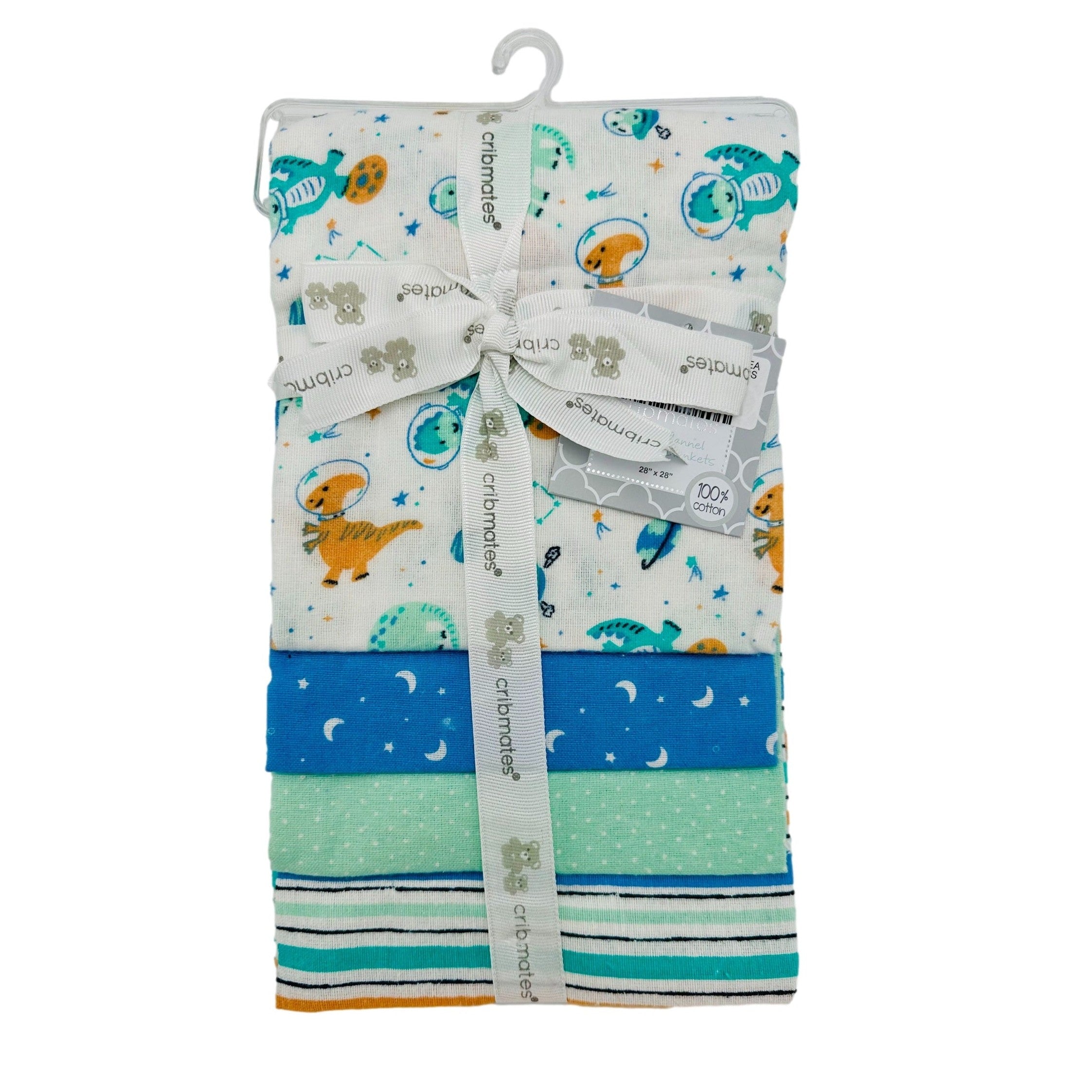 Stacked baby flannel blankets with space dinosaur print and stripe, polka dot, and moon/star patterns, tied with branded ribbon, hanging on a hook.